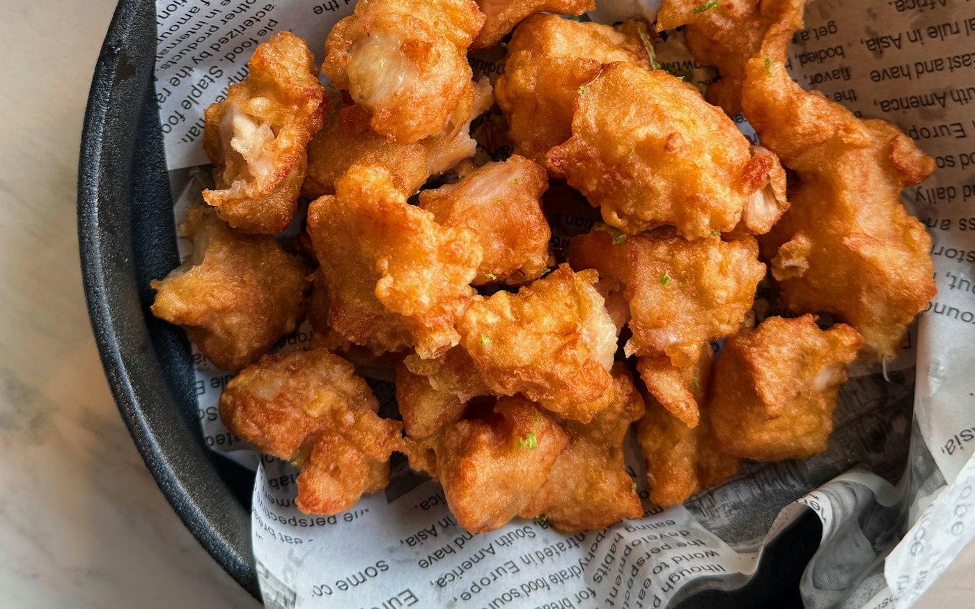 Fried cauliflower in a paper-lined basket