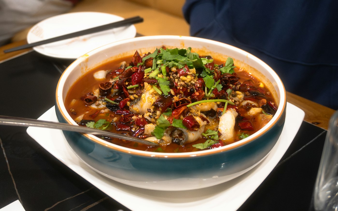 Fish in a chili broth with dried red chilies and herbs